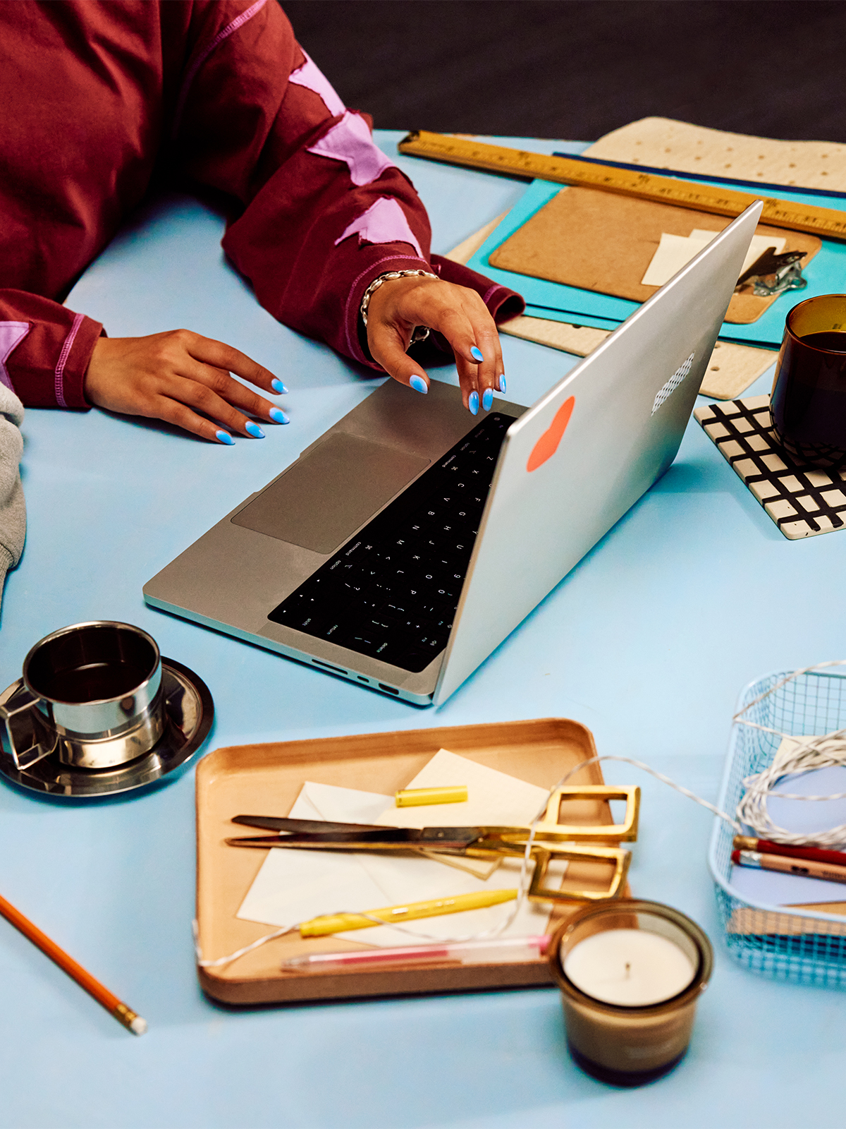 Etsy seller working on a laptop at a studio table